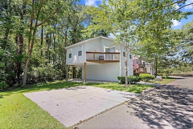View of back of property featuring a front yard and a carport