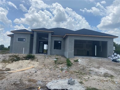View of front of home featuring stucco siding, a g