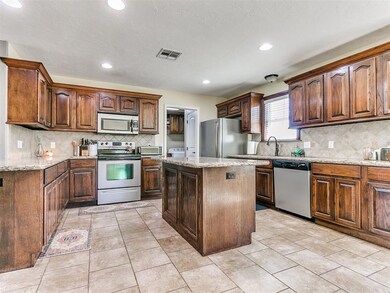 Kitchen with light tile flooring, appliances with 