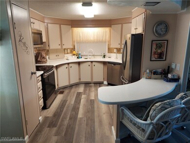 Kitchen with a textured ceiling, stainless steel a