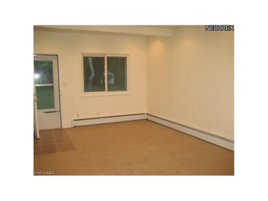 Family room with fresh paint and new carpet.