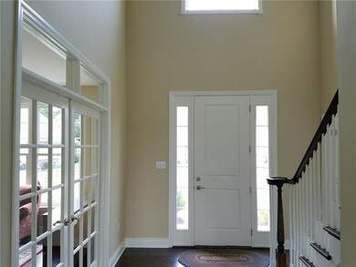 2 Story Entry with hardwood floor.  French doors w