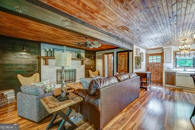 Rustic Meets Refined - A wood-burning fireplace anchors the open-concept living space with farmhouse elegance.