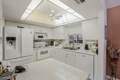 Kitchen is bright and tiled.
