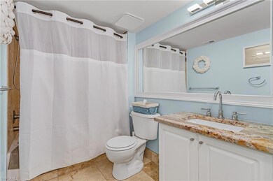Full bathroom featuring shower / bath combo, vanity, and light tile patterned flooring