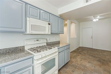 Kitchen featuring white appliances, a ceiling fan, and gray cabinets