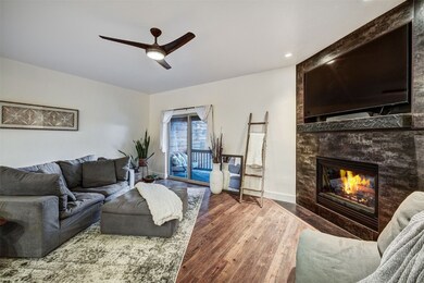 Living area featuring a ceiling fan, wood finished
