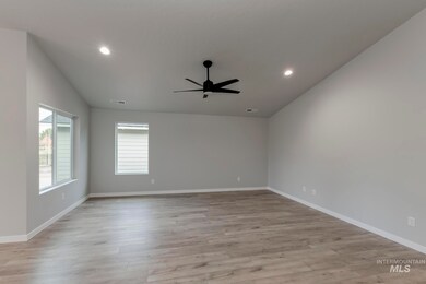 Spare room with light wood-style floors, recessed lighting, a ceiling fan, and vaulted ceiling
