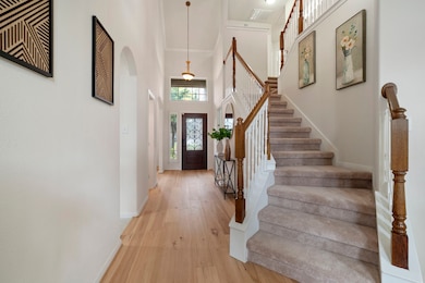 Grand entry with soaring ceilings, modern iron doo
