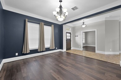 Elegant dining room with dark blue accent walls th
