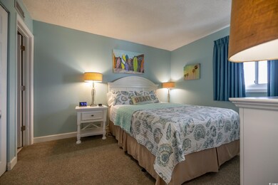 Carpeted bedroom featuring a textured ceiling