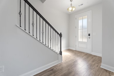 Entrance foyer with wood-type flooring