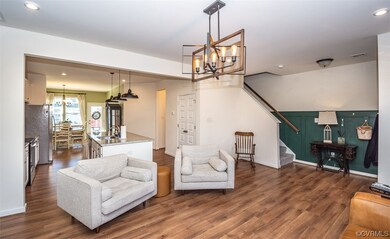 Living room with dark wood-type flooring, sink, an