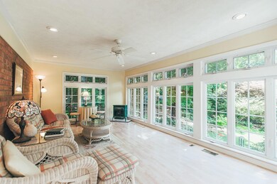 Spacious sunroom! A great spot to relax and enjoy the beautifully landscaped backyard.