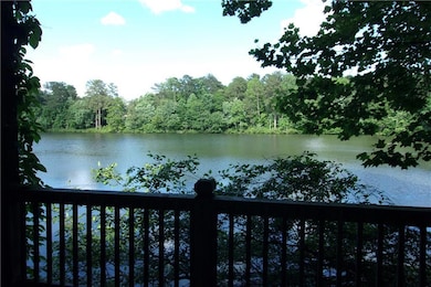 Water view with a heavily wooded area