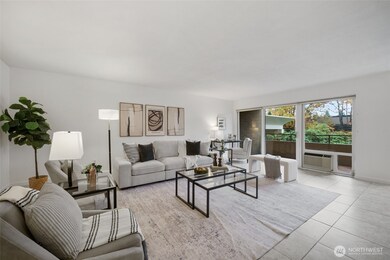 Large windows and a sliding glass door fill the space with natural light and invite you out to the private deck.