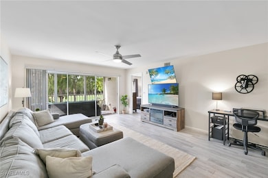 Living area with wood look tile floors and ceiling fan