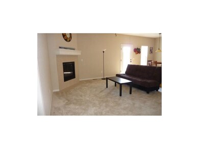 Spaciuos living room with corner fireplace.