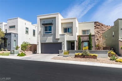 Contemporary house with stucco siding, driveway, a residential view, a fenced front yard, and a garage