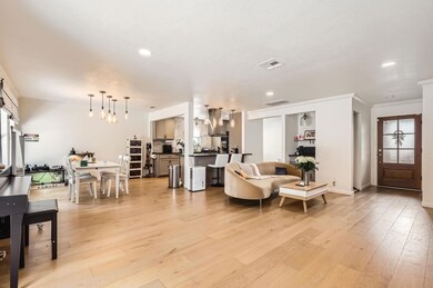 Living area featuring ornamental molding, recesse