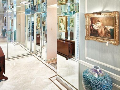 Mirrored foyer and guest coat closet.
