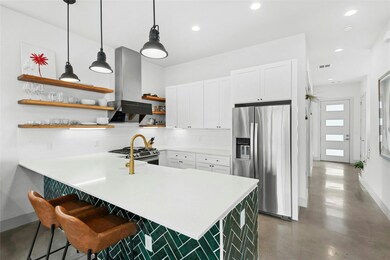 Kitchen featuring open shelves, light countertops