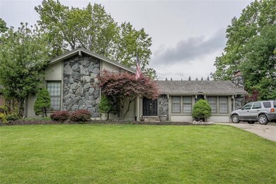 L shaped ranch style home. Garage on left side and