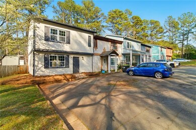 View of front of house with stucco siding and fenc