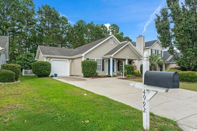 View of front of house with a garage and a front y