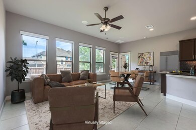 Living room featuring a ceiling fan, baseboards, 