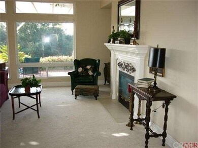 Living room with gorgeous fireplace, windows to th