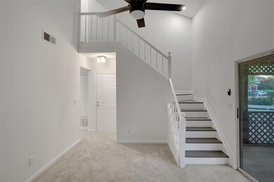 Staircase featuring a high ceiling, carpet floors,