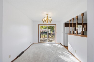 Unfurnished dining area with a chandelier and carpet flooring