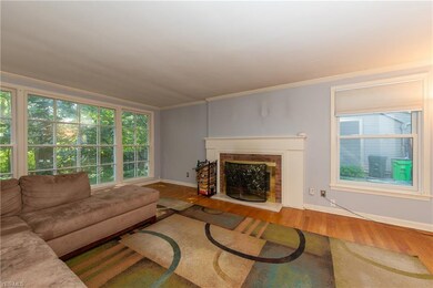 The Living Room with hardwood floor and brick surround fireplace