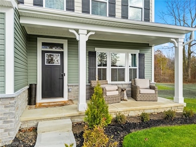 Doorway to property with a porch and stone siding