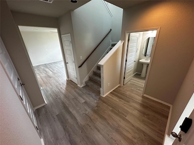 Staircase featuring wood finished floors and baseboards