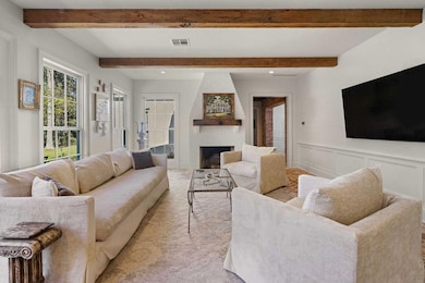 Keeping room off the kitchen with functional fireplace and exposed beams. Tons of natural light.