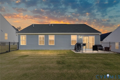 Back of house with roof with shingles and a patio