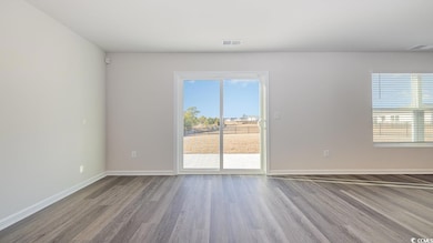 Empty room with hardwood / wood-style floors