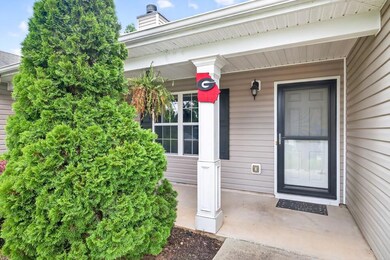 Property entrance featuring a chimney and covered porch