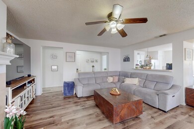 Living room with ceiling fan, wood-type flooring, 