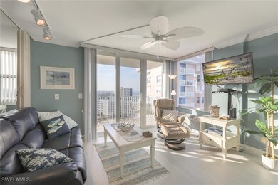 Living room with ceiling fan, ornamental molding,