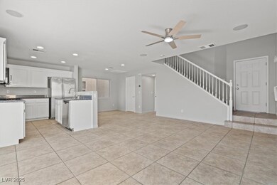 Kitchen with open floor plan, light tile patterned
