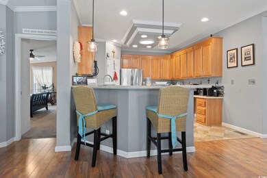 Kitchen featuring kitchen peninsula, ornamental mo