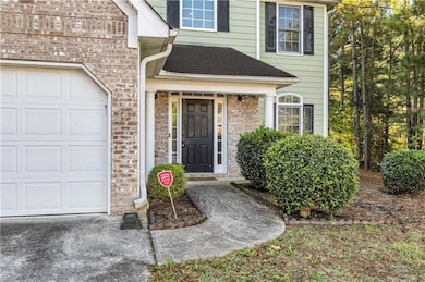 Property entrance with a garage and brick siding
