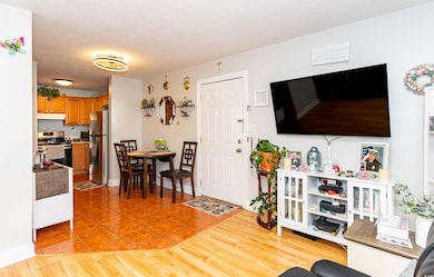 Living room with light tile patterned floors and a