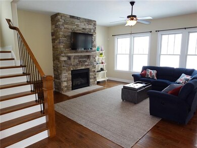 The family room boasts a stone gas fireplace that 