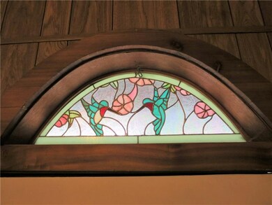 Just above entry doorway is a lovely stained glass