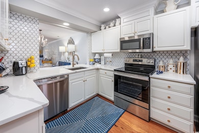 Kitchen featuring a sink, decorative backsplash, o