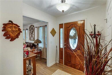 Entrance foyer with light wood-style floors and plenty of natural light